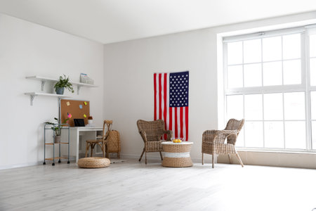 Interior of stylish room with modern workplace and USA flagの写真素材