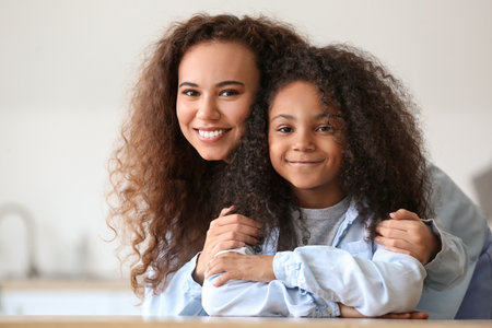 African-American little girl with her mother at homeの写真素材