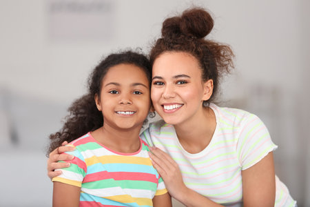 African-American little girl with her mother at homeの写真素材