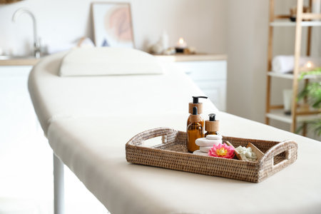 Tray with beautiful spa composition on couch in salonの写真素材