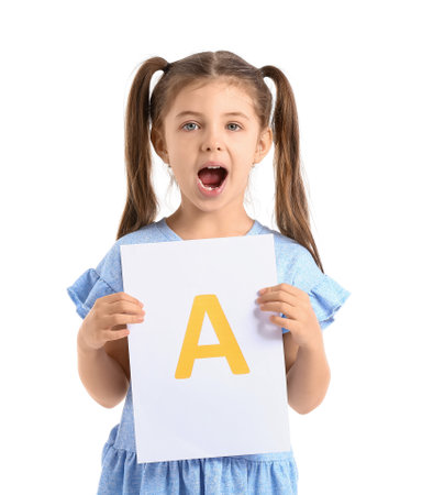 Little girl holding paper sheet with letter A on white backgroundの写真素材