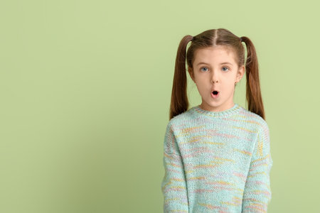 Little girl training pronounce letters on color backgroundの写真素材