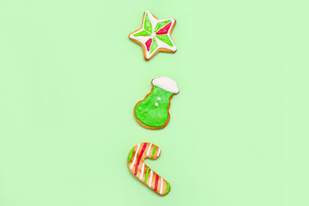 Tasty Christmas cookies on green backgroundの写真素材