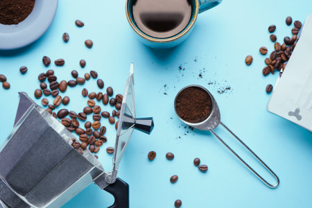 Composition with geyser coffee maker and beans on blue backgroundの写真素材
