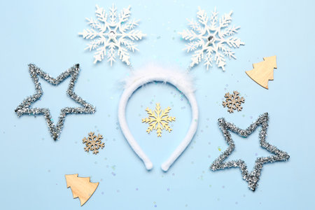 Composition with beautiful Christmas headband and decorations on light blue backgroundの写真素材