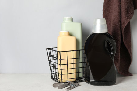 Laundry detergents and towels on table against gray backgroundの写真素材