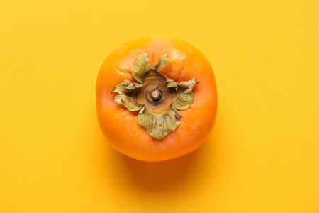 Fresh ripe persimmon on color backgroundの写真素材