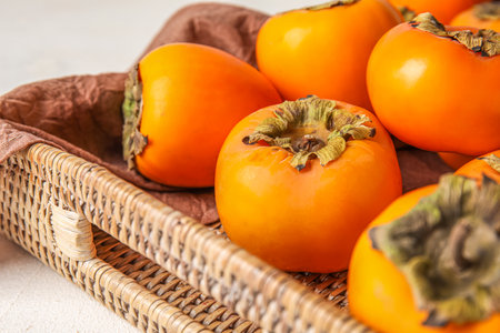 Tray with ripe persimmons, closeupの写真素材