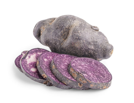 Slices of raw purple potato on white backgroundの写真素材