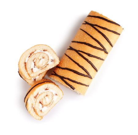 Cut sponge cake roll on white backgroundの写真素材