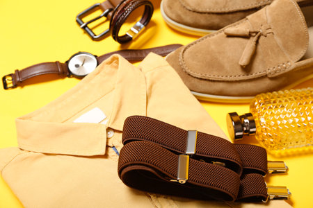 Male shirt, suspenders and accessories on yellow background, closeupの写真素材
