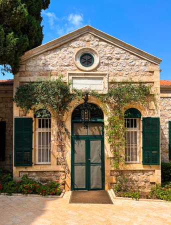 Facade of stone house with green plants on sunny dayの写真素材