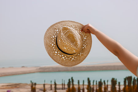 Little girl with wicker hat in desert, closeupの写真素材