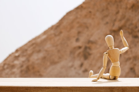 Wooden mannequin on fence in desertの写真素材