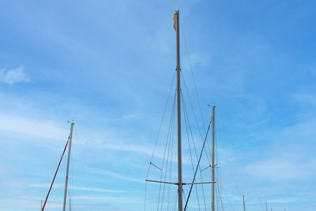 View of masts against blue sky