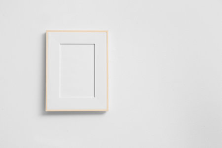 Blank photo frame on white wall