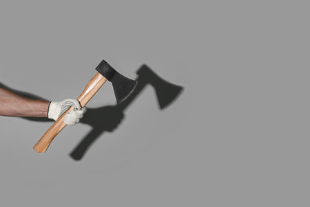 Man with ax on gray background
