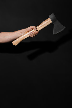 Man with ax on black background