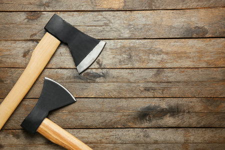 Axes on wooden background, top viewの写真素材