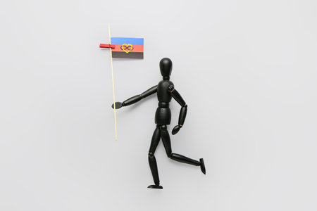 Black mannequin with polyamory flag on gray background