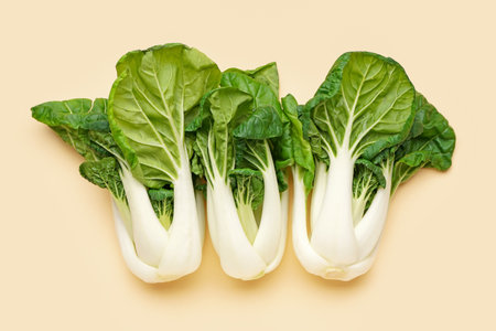 Fresh ripe pak choi cabbages on color backgroundの写真素材