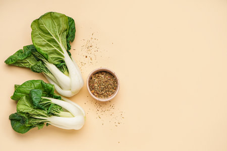 Fresh pak choi cabbage and bowl of spices on color backgroundの写真素材