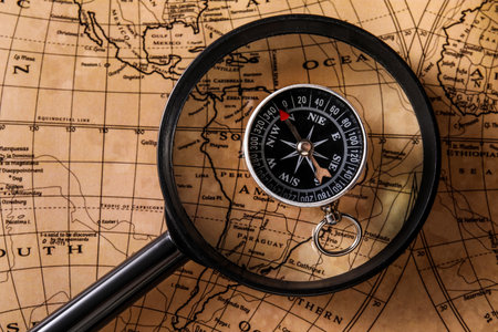 Compass and magnifier on world mapの写真素材