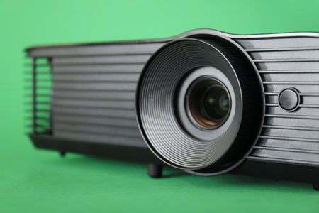 Black video projector on green background, closeupの写真素材