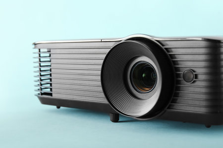 Black video projector on blue background, closeupの写真素材