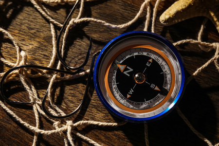 Compass with hooks and net on dark wooden backgroundの写真素材