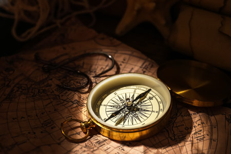 Golden compass and hooks on world mapの写真素材