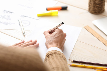 Young male calligrapher working in office, closeupの写真素材