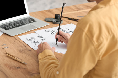 Young male calligrapher working at homeの写真素材