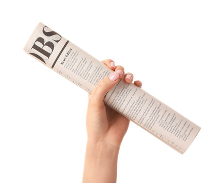 Female hand and newspaper on white backgroundの写真素材
