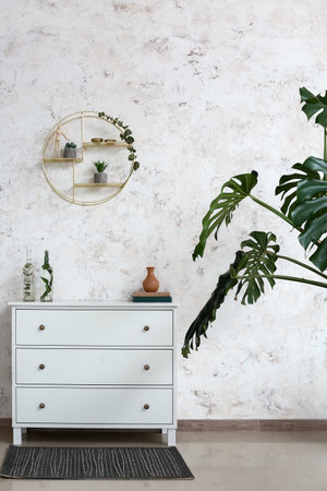 Interior of stylish living room with chest of drawers
