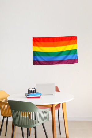Modern workplace with flag of LGBT hanging on wall in roomの写真素材