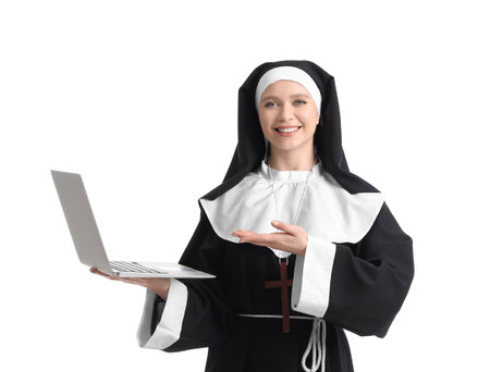Young nun with laptop on white backgroundの写真素材