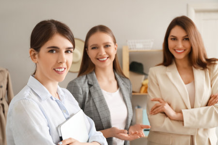 Female business owner and sellers in shopの写真素材