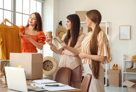 Female business owner and sellers working in shopの写真素材