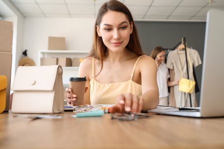 Female business owner processing order in warehouse storeの写真素材
