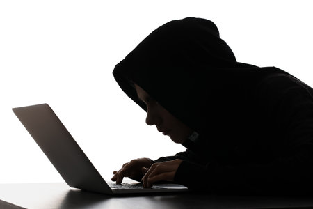 Silhouette of hacker with laptop on white background