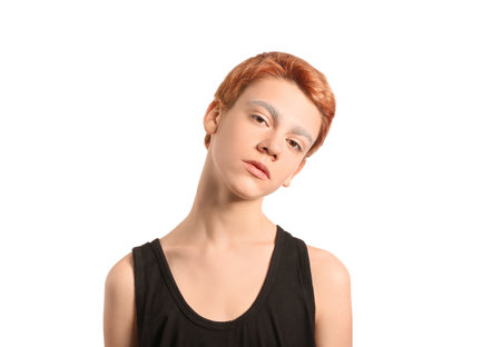 Teenage boy with dyed eyebrows on white backgroundの写真素材