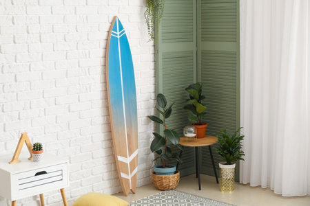 Surfboard with houseplants in interior of roomの写真素材