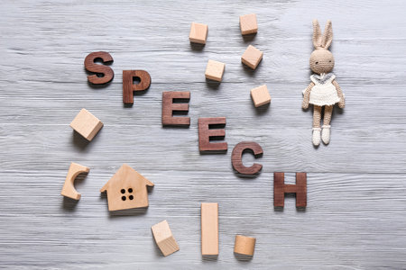 Word SPEECH and toys on gray wooden backgroundの写真素材