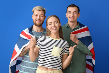 Young people with flag of Great Britain on color backgroundの写真素材