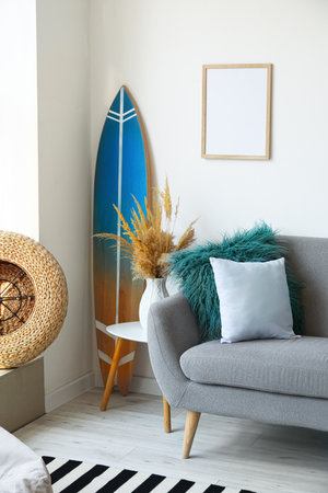 Interior of modern stylish room with surfboard and sofaの写真素材