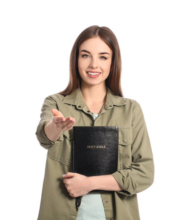 Young woman with Bible on white background
