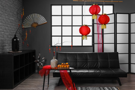 Interior of living room with couch, table and decor for Chinese New Year celebrationの写真素材