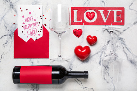 Card with text HAPPY VALENTINE'S DAY, word LOVE, wine, glasses and hearts on grunge backgroundの写真素材