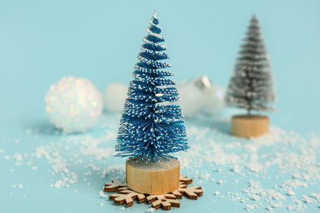 Decorative Christmas trees and snow on color backgroundの写真素材